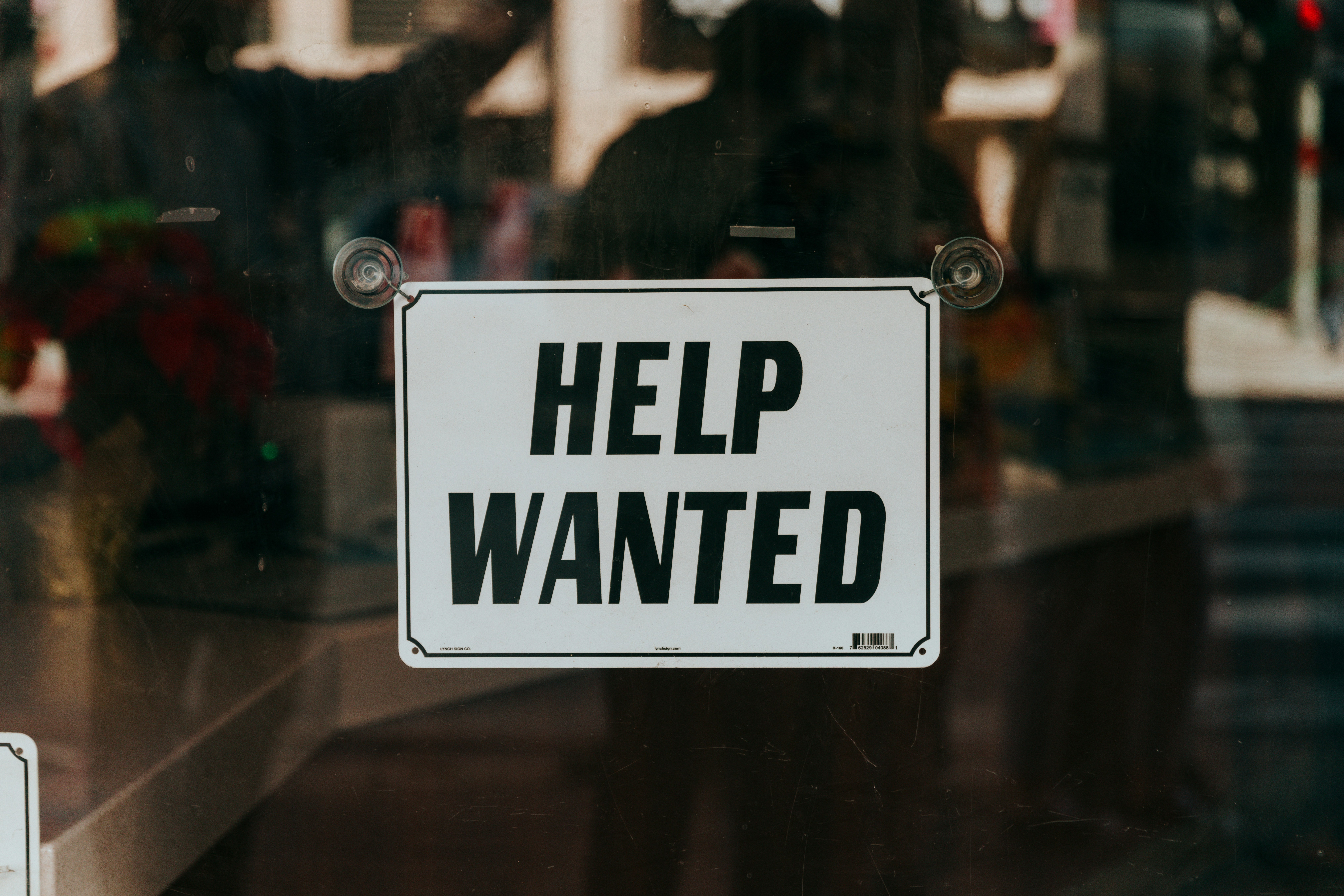 A help wanted sign in the window